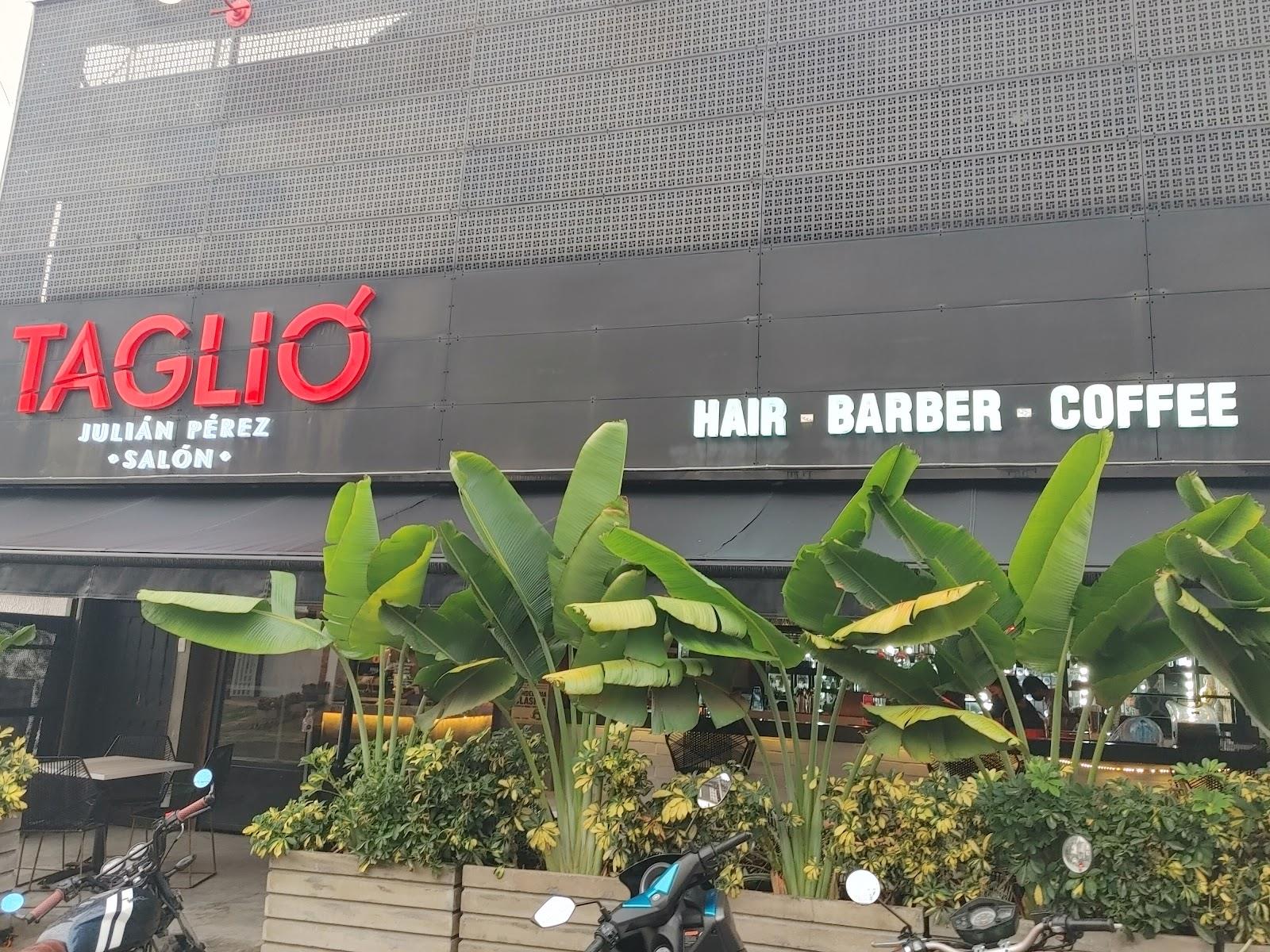 Fachada de TAGLIO con el letrero HAIR, BARBER, COFFEE y plantas